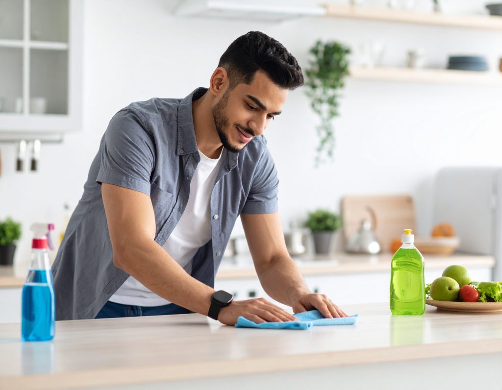 cleaning kitchen counter in a beautiful home cleaning products are on the cou 224015